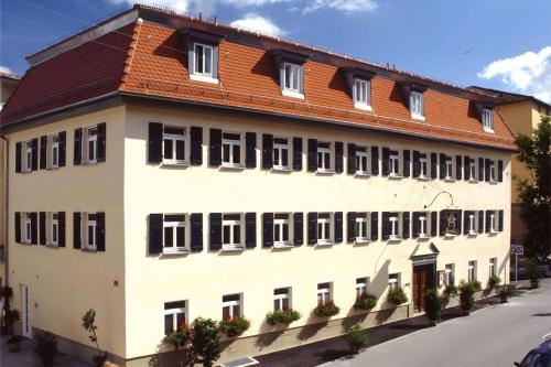 a large white building with a red roof at Aspire Kronprinz, Trademark Collection by Wyndham in Schwäbisch Hall