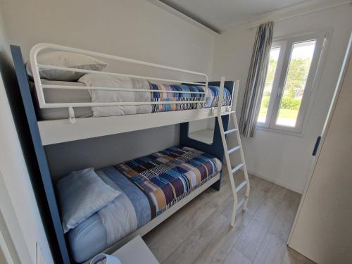a room with two bunk beds with a ladder at Appartamento MaRi in Fano
