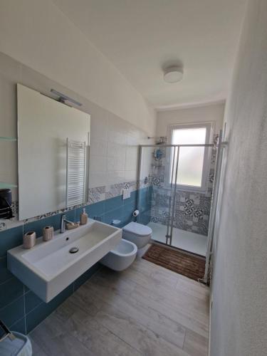 a bathroom with a sink and a toilet and a shower at Appartamento MaRi in Fano