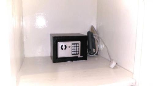 a phone in the corner of a white wall at Varadero Zanzibar Hotel in Kendwa