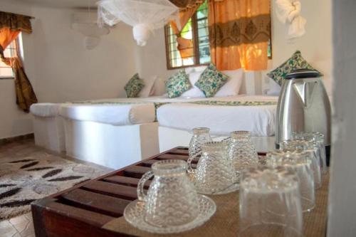 a room with a couch and a table with glass jars at Varadero Zanzibar Hotel in Kendwa
