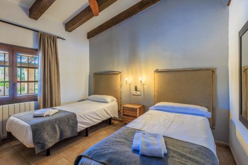 1 Schlafzimmer mit 2 Betten und einem Fenster in der Unterkunft Villa Benvingut in El Port
