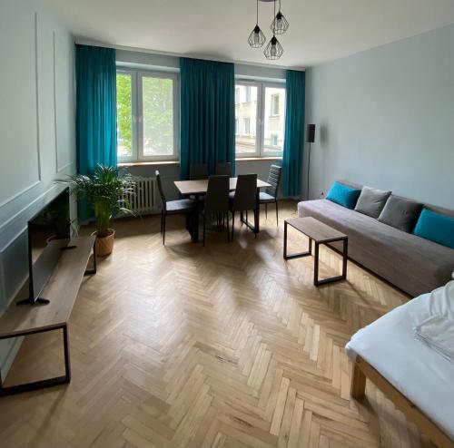 a living room with a couch and a table at Apartament III Aleja NMP in Częstochowa