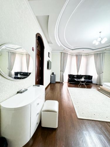 a bathroom with a white sink and a mirror at De Villa Hotel in Samarkand
