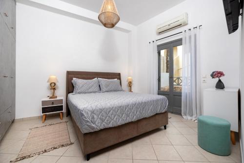 a bedroom with a bed and a blue stool in it at Gabriel House in Monolithos