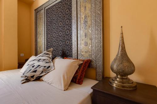 a bedroom with a bed with pillows and a headboard at Casa da Moura in Lagos