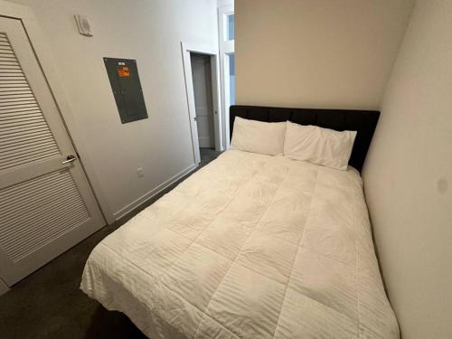 a bedroom with a large bed with white sheets at Sleeping in the City! in Birmingham