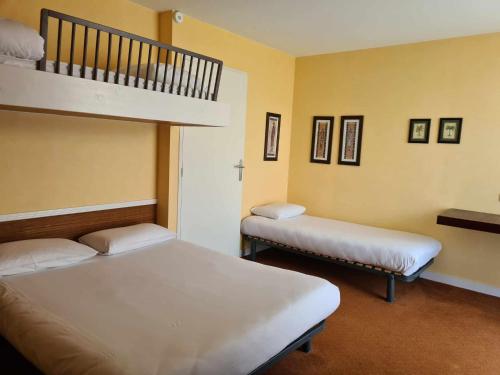 a room with two beds and a bunk bed at Hotel Cap D'Ambre in La Barre-de-Monts
