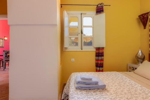 a bedroom with a bed with towels on it at Casa da Moura in Lagos