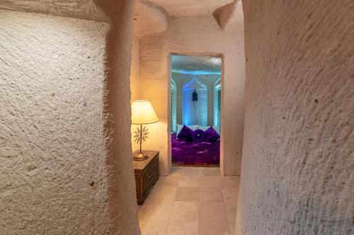 a hallway with a mirror and a lamp on a table at Hu of Cappadocia - Special Class in Uchisar