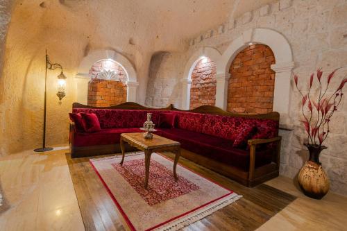 a living room with a red couch and a table at Hu of Cappadocia - Special Class in Uchisar