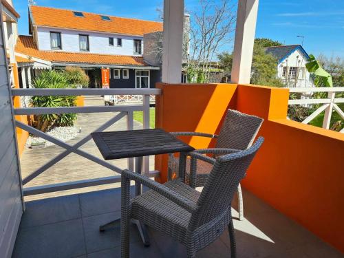 a balcony with two chairs and a table on a balcony at Hotel Cap D'Ambre in La Barre-de-Monts
