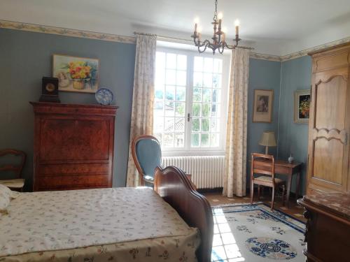 une chambre avec un lit, une table et une fenêtre dans l'établissement Authentique maison du 17e siècle dans propriété viticole, idéalement située, à Sablet