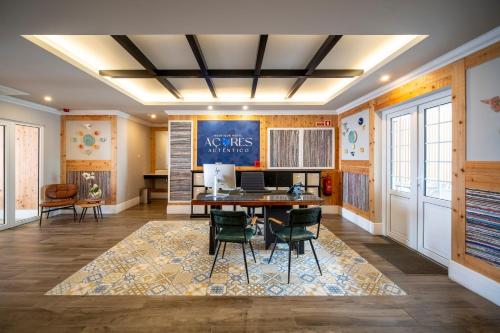 an office with a desk and chairs in a room at Açores Autêntico Boutique Hotel in Angra do Heroísmo
