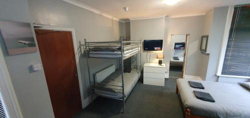 a small room with a bed and a bunk bed at Blackpool North Close to Station - With Free Car Parking in Blackpool