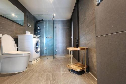 a bathroom with a toilet and a glass shower at SelfCheckIn The State Tower RiverView 2Bedroom BTS ICONSIAM Silom Sathon in Bangkok