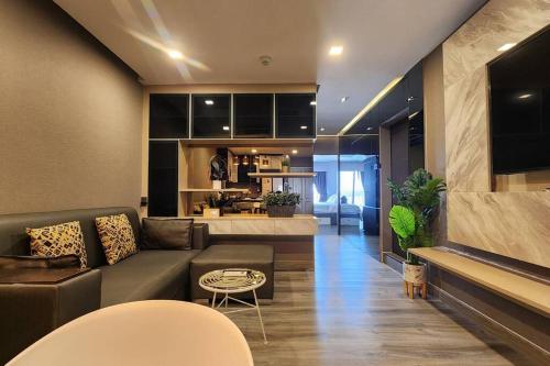 a living room with a couch and a table at SelfCheckIn The State Tower RiverView 2Bedroom BTS ICONSIAM Silom Sathon in Bangkok
