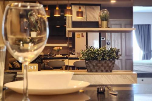 a wine glass sitting on top of a table at SelfCheckIn The State Tower RiverView 2Bedroom BTS ICONSIAM Silom Sathon in Bangkok