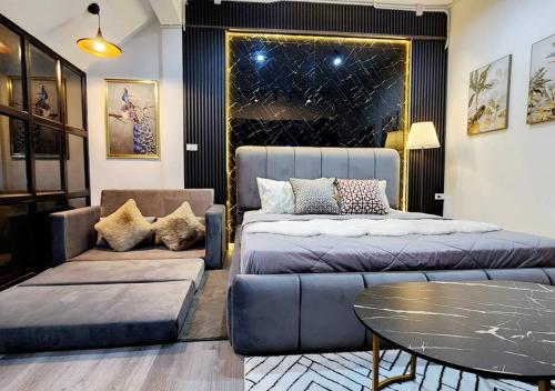 a bedroom with a bed and a couch and a table at LS 1 Lasalle House,bts,Suvarnabhumi ,mega bangna in Bangkok