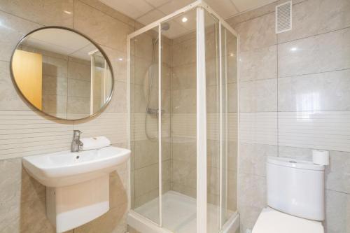 a bathroom with a shower and a sink and a toilet at Ibersol Spa Aqquaria in Salou