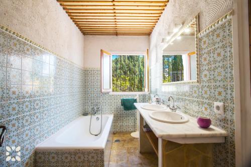 a bathroom with two sinks and a tub and a bath tub at Villa Timeris by Abahana Villas in Calpe