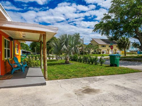 a porch of a house with a blue chair at Sunny Delight I in Cape Canaveral
