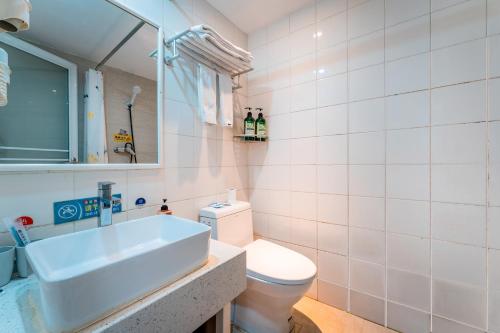 a bathroom with a sink and a toilet at Xi'an See Tang Guesthouse in Xi'an