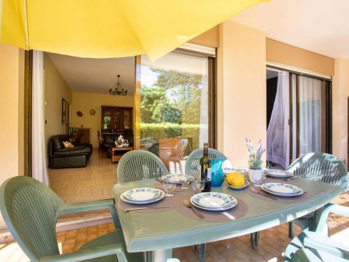 a dining room table and chairs with a table and chairsktop at Apartment Marines de Villeneuve by Interhome in Villeneuve-Loubet