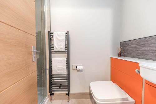 a small bathroom with a toilet and a sink at Blue Sky Cottage in Keswick