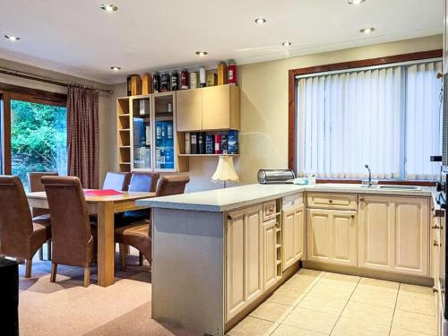 a kitchen with a table and a dining room at Chalet Glen View by Interhome in Spean Bridge