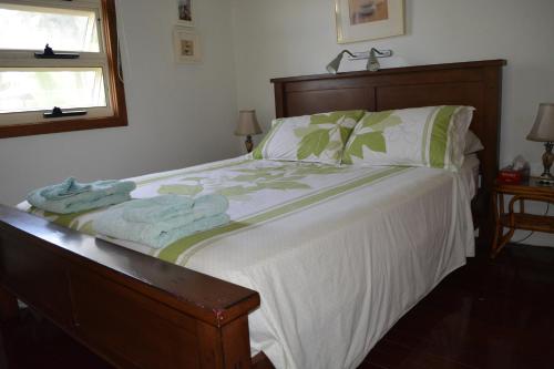 a bedroom with a bed with towels on it at Hibiscus House in Flying Fish Cove