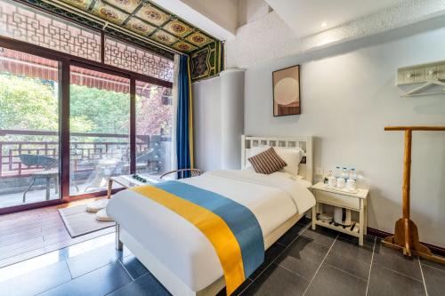 a bedroom with a large bed and a large window at Xi'an See Tang Guesthouse in Xi'an