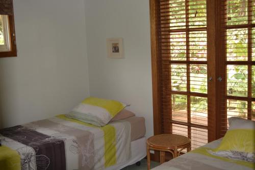 A bed or beds in a room at Hibiscus House