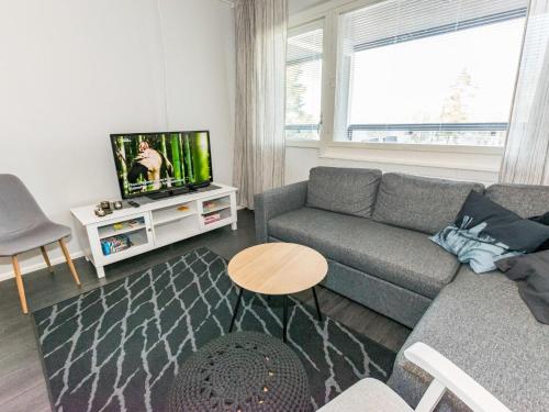 - un salon avec un canapé et une télévision dans l'établissement Holiday Home Vuorihuoneistot 608 by Interhome, à Sastamala