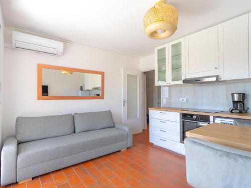ein Wohnzimmer mit einem Sofa in der Küche in der Unterkunft Apartment Parcs du Lavandou-10 by Interhome in Le Lavandou