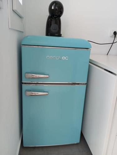 a blue refrigerator with a phone on top of it at Gaviotas Beach Golf Love 11 in Almerimar
