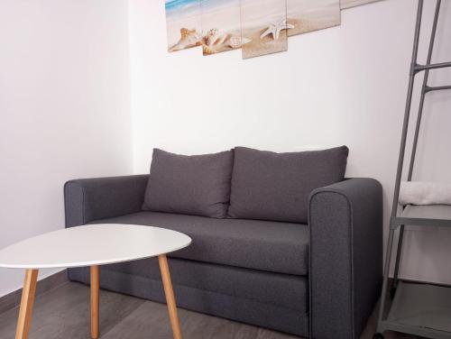 a living room with a couch and a table at Gaviotas Beach Golf Love 11 in Almerimar