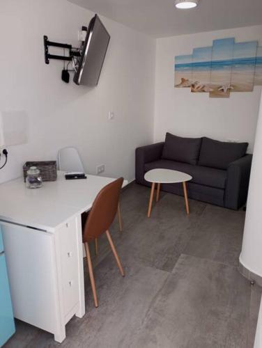 a living room with a couch and a table at Gaviotas Beach Golf Love 11 in Almerimar
