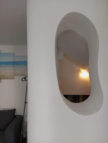 a mirror on a wall in a room with a couch at Gaviotas Beach Golf Love 11 in Almerimar