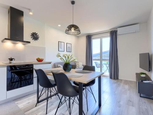 a kitchen and dining room with a table and chairs at Apartment Acqua e sale by Interhome in Rabac