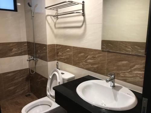 La salle de bains est pourvue d'un lavabo et de toilettes. dans l'établissement Era Apartment Nguyen Van Huyen, à Hanoï