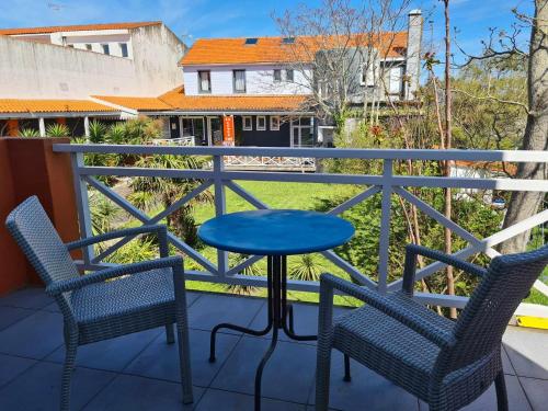a blue table and two chairs on a balcony at Hotel Cap D'Ambre in La Barre-de-Monts