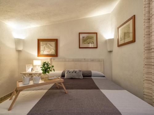 a living room with a bed and a table at Apartment 0-1-M - Marineledda by Interhome in Golfo Aranci