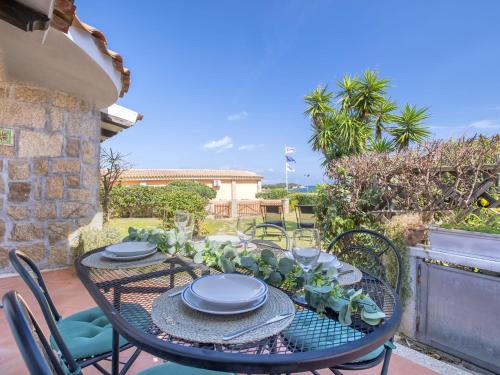 a table with plates and dishes on it on a patio at Holiday Home Damà by Interhome in Cannigione