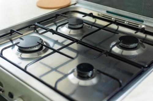 a stove top with four burners on it at Grace House - 15 Minutes To Central London in Thamesmead