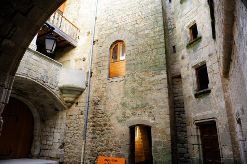 a large stone building with a door and a window at Gite au Rocher in Chassiers