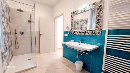 a bathroom with a sink and a shower and a mirror at Olimpo degli Dei in Agerola