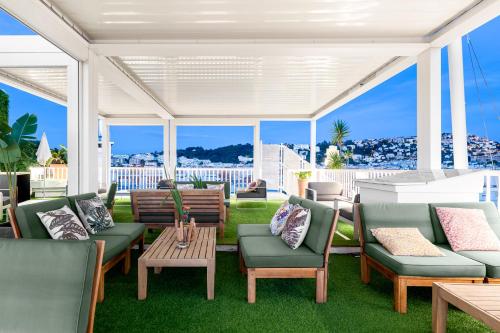 an outdoor patio with chairs and tables and windows at Splendid Hotel & Spa Nice in Nice