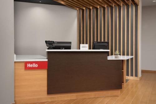 an office with a reception desk with ahello sign at TownePlace Suites by Marriott Cheyenne Southwest/Downtown Area in Cheyenne