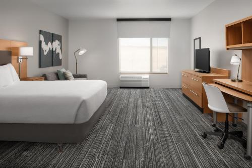 a hotel room with a bed and a desk at TownePlace Suites by Marriott Cheyenne Southwest/Downtown Area in Cheyenne